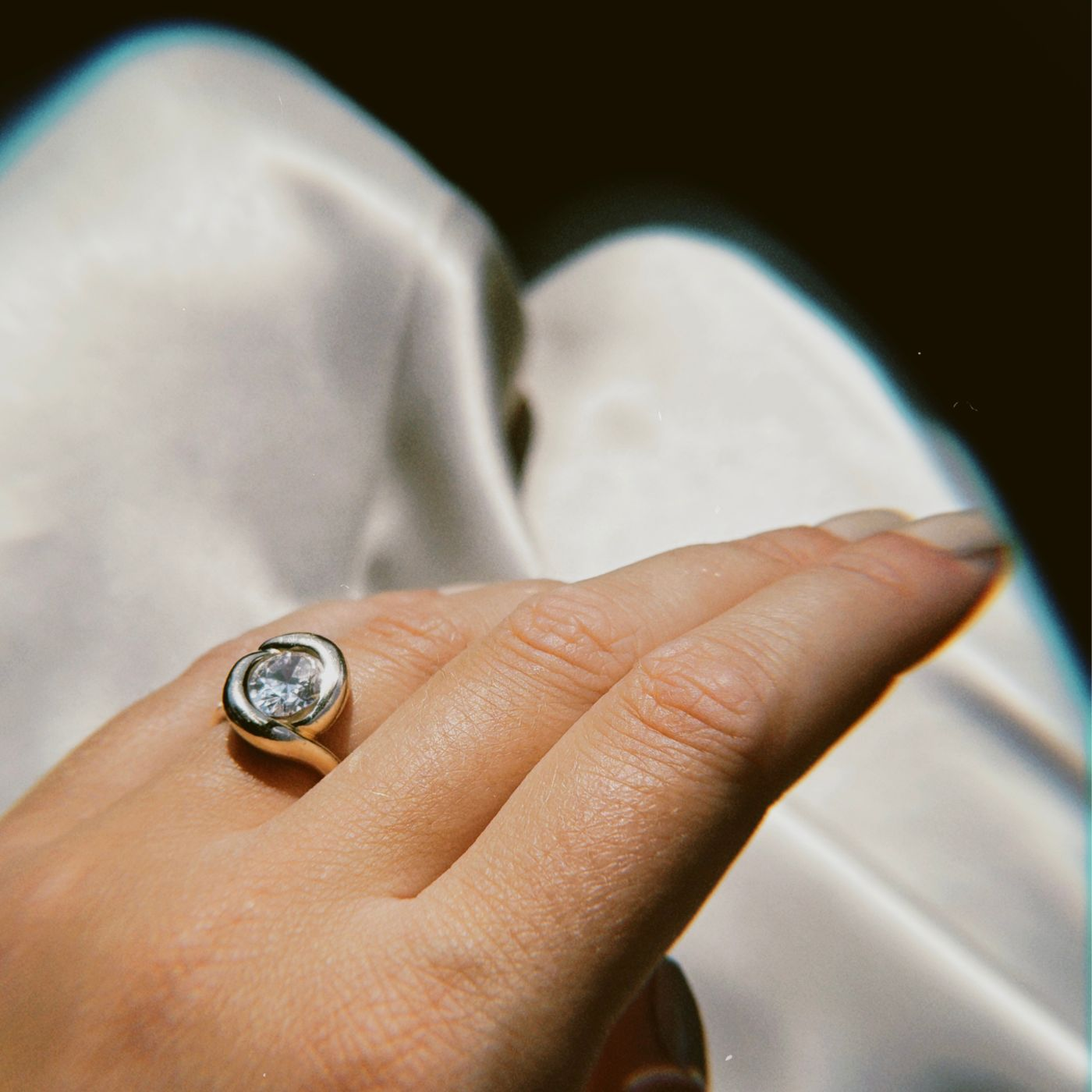 celebrate the milestones with sustainable fine jewelry from AMANDA PAERL. Molten Knot Rings in various genmstones stacked on a womens hands