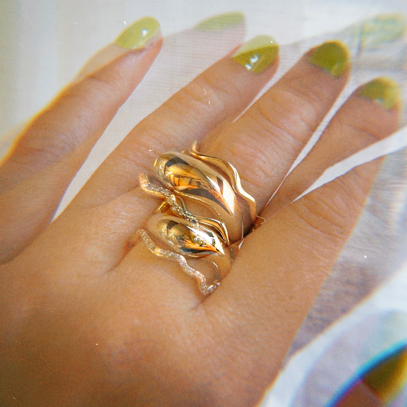 14K Recycled Gold Ripple with marquise stacked with Full Pavé and Plain Ripple Ring on a hand