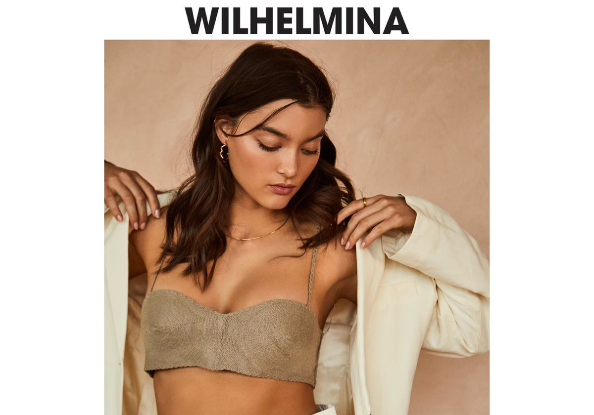 Wilhelmina model wearing AMANDA PEARL jewelry with a beige bra top and ivory blazer.