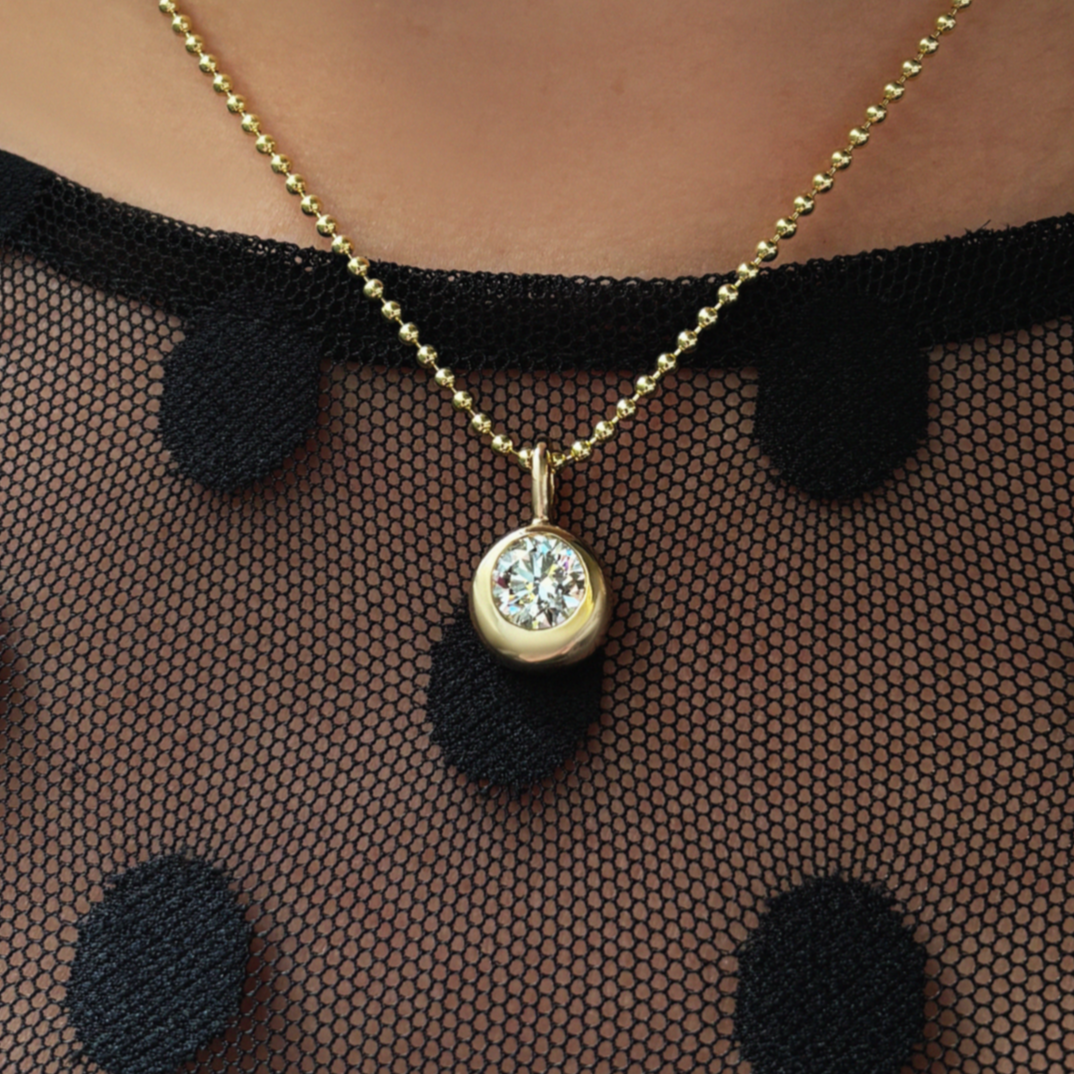 14K Recycled Gold Molten Round Solitaire Charm with Diamond layered on a 2mm bead chain on neck