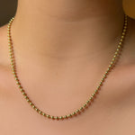 3mm bead chain necklace in yellow gold on the body.