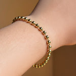 4mm bead chain in yellow gold on the wrist.