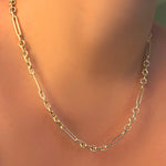 A 14K yellow gold 6 mm irregular cable chain necklace on a model's neck.