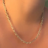 A 14K yellow gold 6 mm irregular cable chain necklace on a model's neck.