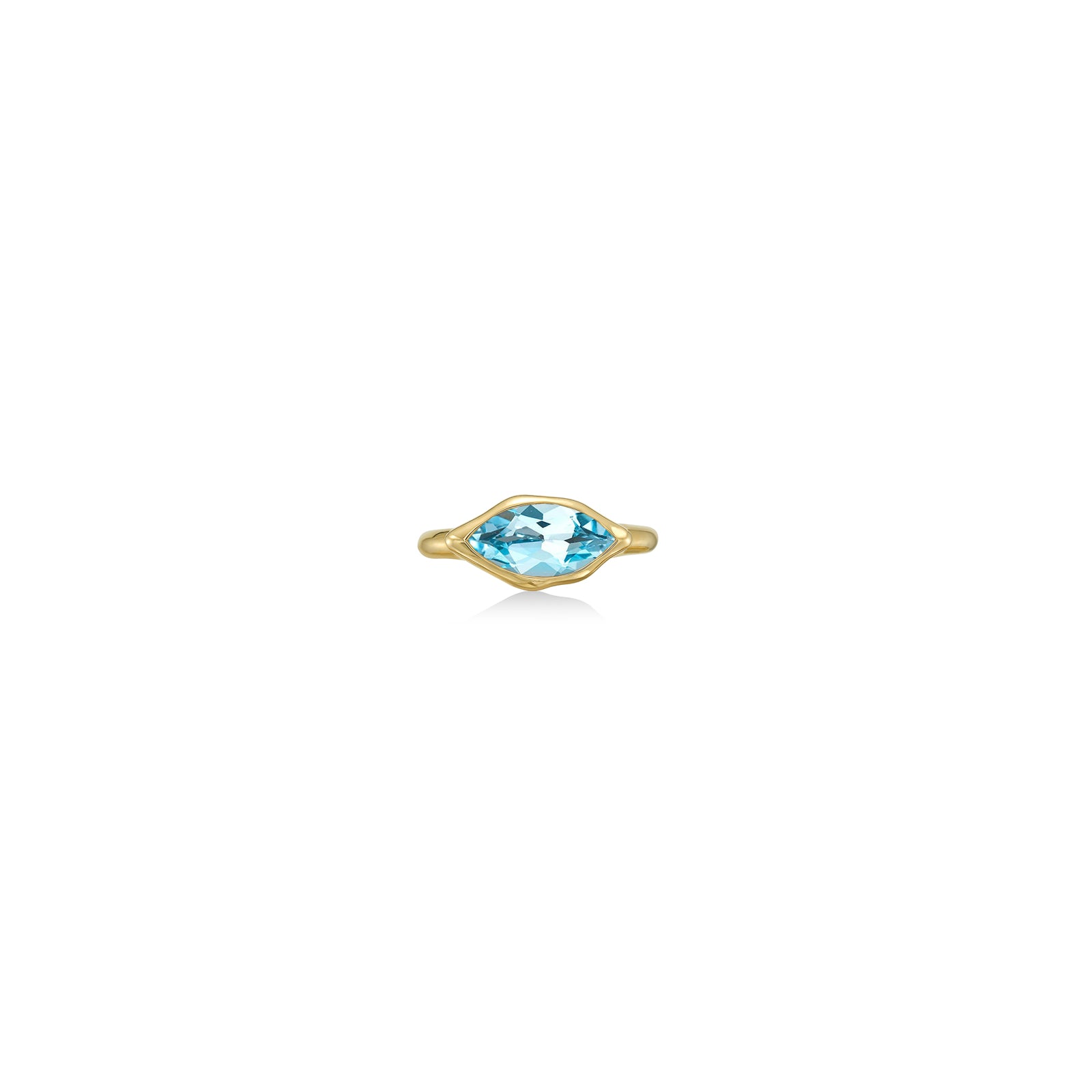 A 14K yellow gold marquise ring, with a bezel set faceted blue topaz gemstone, sits on a white background with drop shadow.