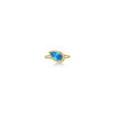 A 14k yellow gold molten solitaire ring with pear-shaped blue topaz on a white background.