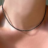 Shimmering slim gemstone beaded necklace made of 2mm faceted stones in Black Spinel on a gold linking lobster clasp. 