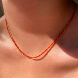 Shimmering slim gemstone beaded necklace made of 2mm faceted stones in carnelian on a gold linking lobster clasp. 