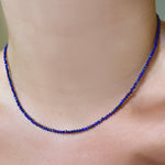 Shimmering slim gemstone beaded necklace made of 2mm faceted stones in lapis on a gold linking lobster clasp. 