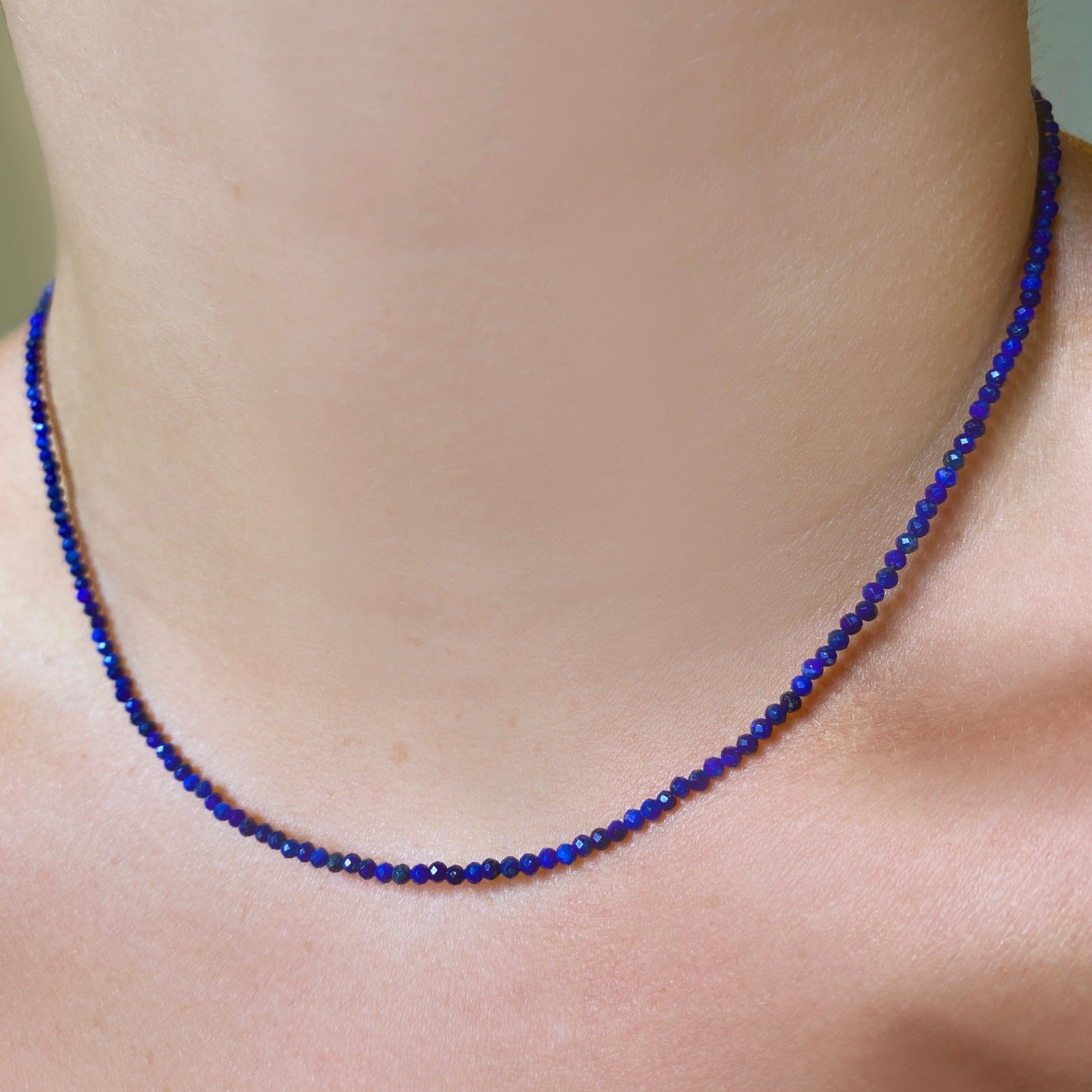 Shimmering slim gemstone beaded necklace made of 2mm faceted stones in lapis on a gold linking lobster clasp. 