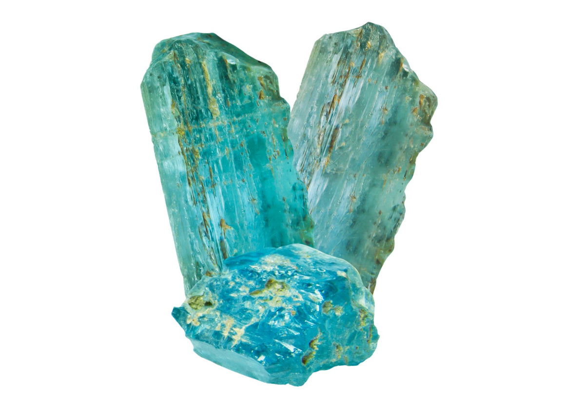 A raw blue topaz gemstone sits on a white background
