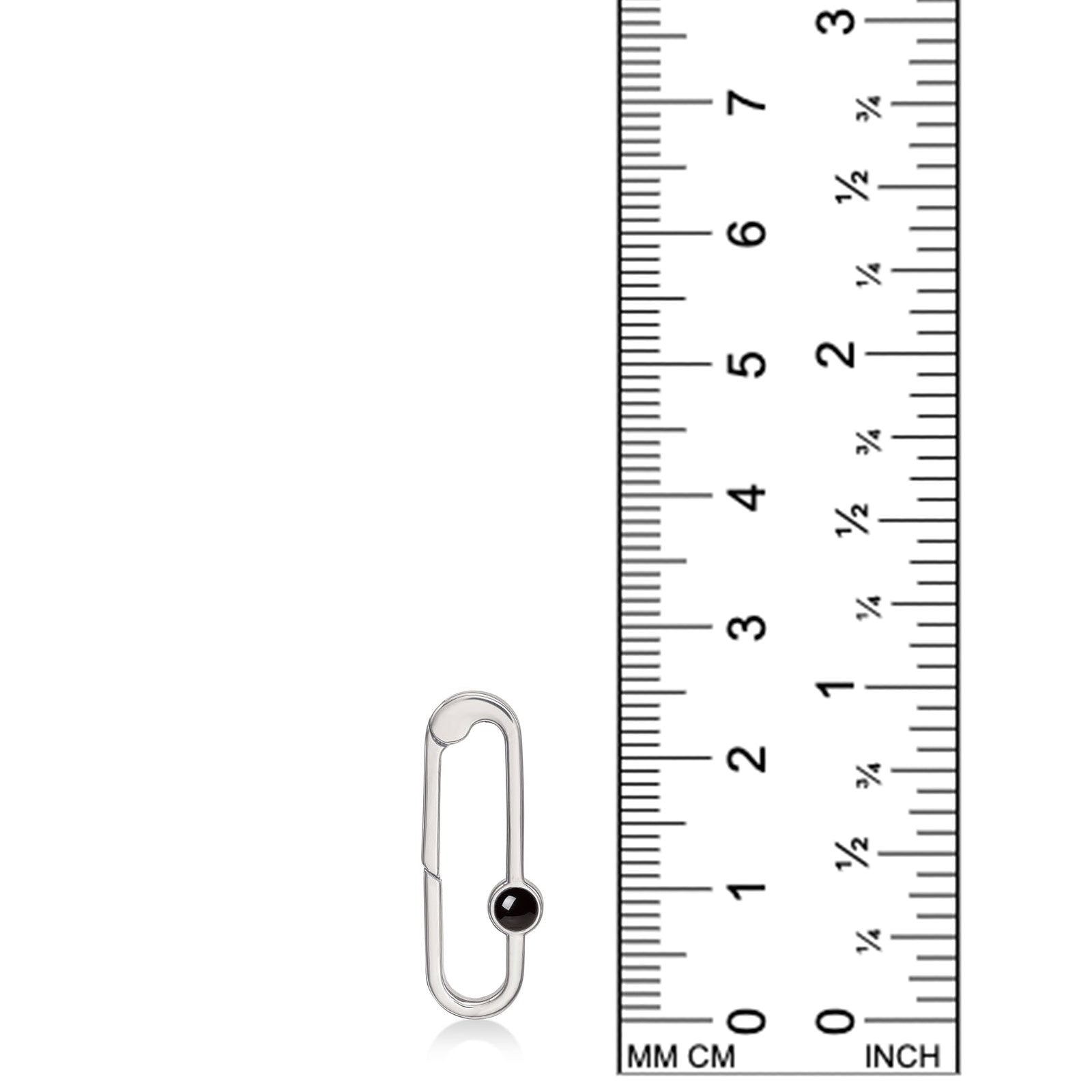 Recycled sterling silver charm lock with a black onyx cabochon, from AMANDA PEARL, set against a ruler for scale.