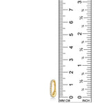 A 14K recycled yellow gold charm lock with lab grown diamonds from AMANDA PEARL sits against a ruler for scale. 