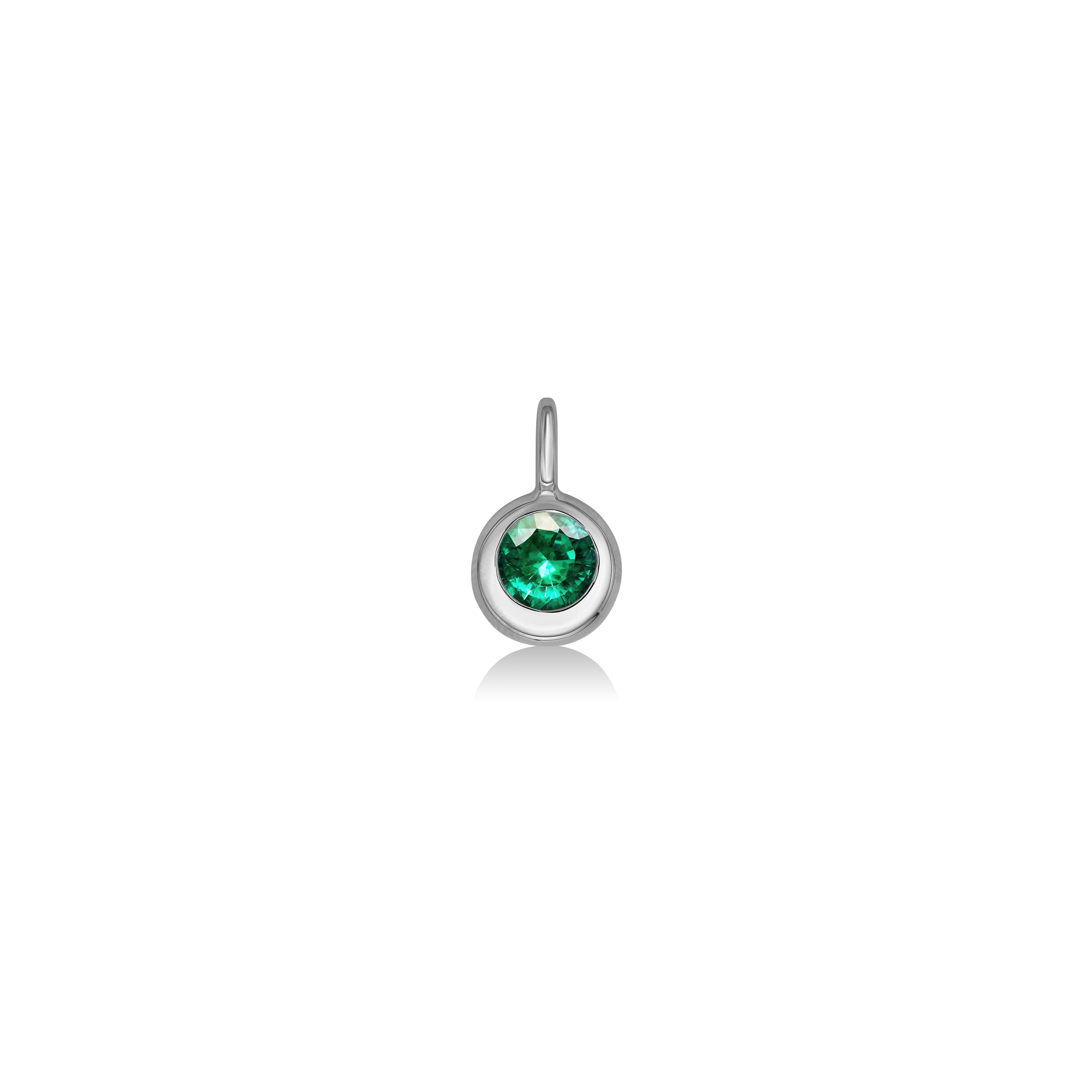 AMANDA PEARL Molten solitaire pendant in recycled 14k recycled white gold with a round, cultivated emerald on a white background. 