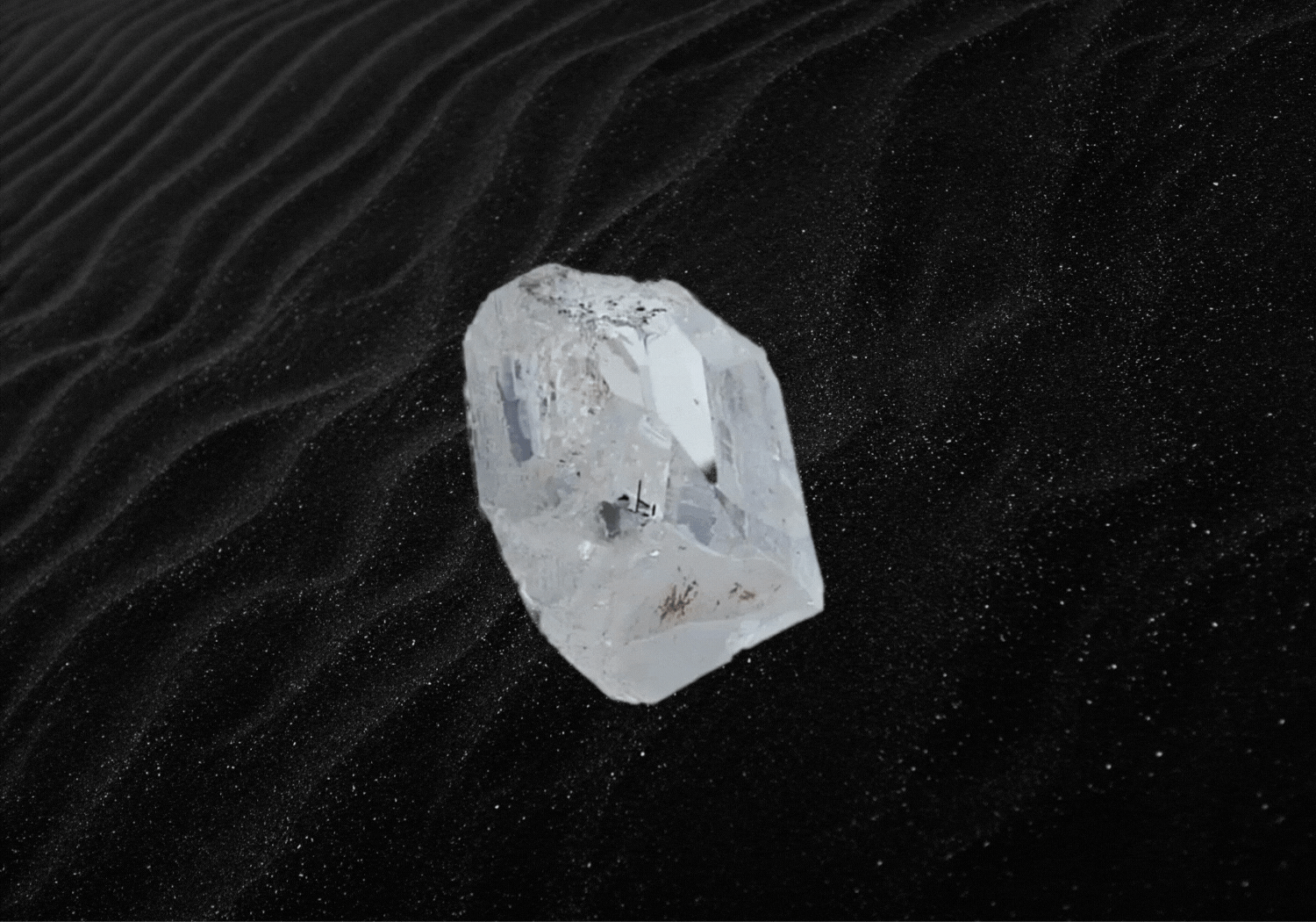 Raw diamond over black sand