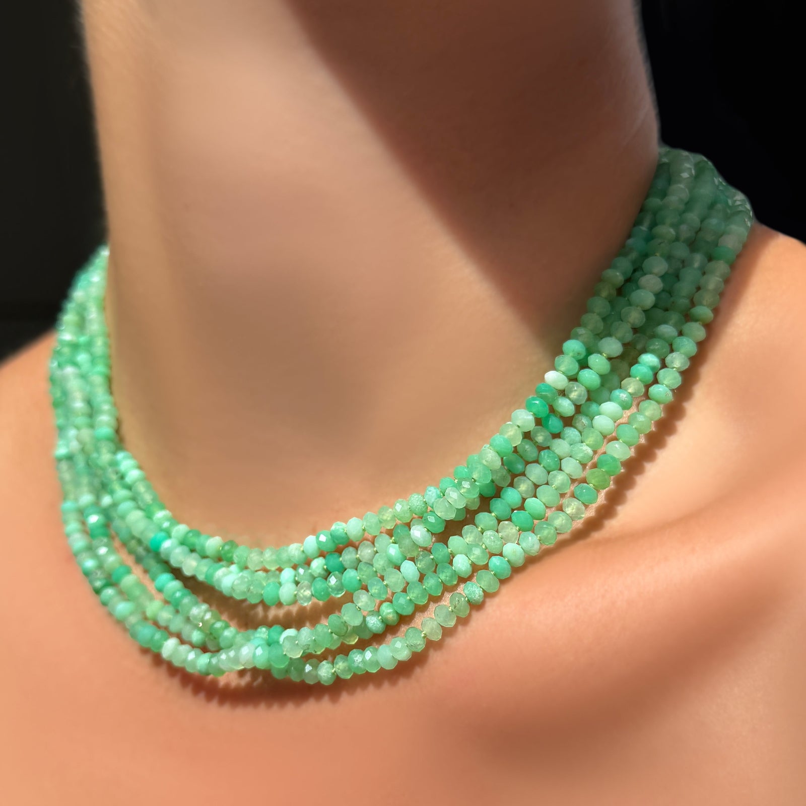 AMANDA PEARL a stack of Faceted Chrysoprase Necklaces on Sterling Silver Evolution Clasp on a model's neck.