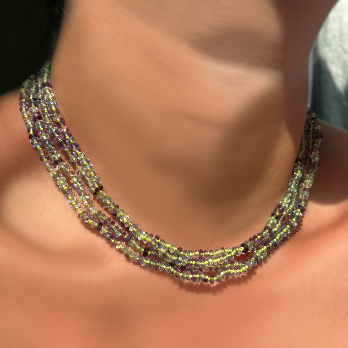 Faceted Fluorite on Neon layered on the neck.