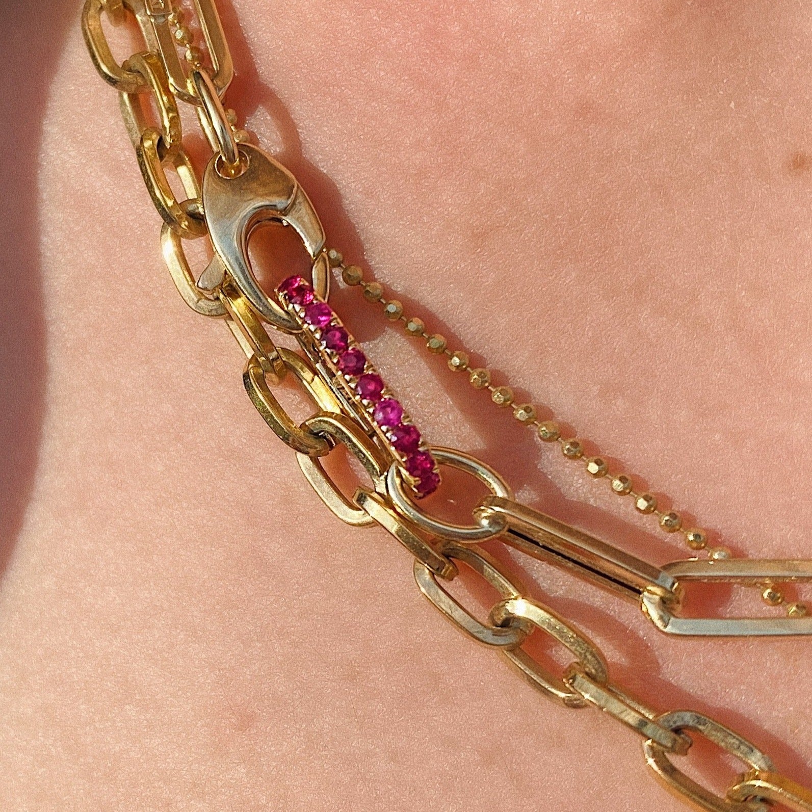 14K Gold Small Ruby Charm Lock on a Chunky paperclip chain necklace layered with multiple chains