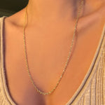 Irregular cable chain worn at 24" paired with a beige scoop neck knit.
