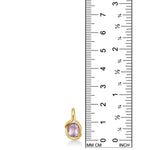 A 14K recycled yellow gold Molten knot charm with amethyst gemstone, set against a ruler showing it's height to be 19mm. 