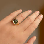14k recycled gold Grass Green Tourmaline Molten Knot Ring styled on a hand