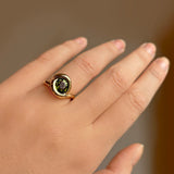 14k recycled gold Grass Green Tourmaline Molten Knot Ring styled on a hand