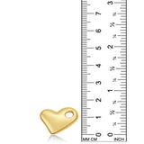 A 14K recycled yellow gold molten heart charm from AMANDA PEARL sits against a ruler for scale.
