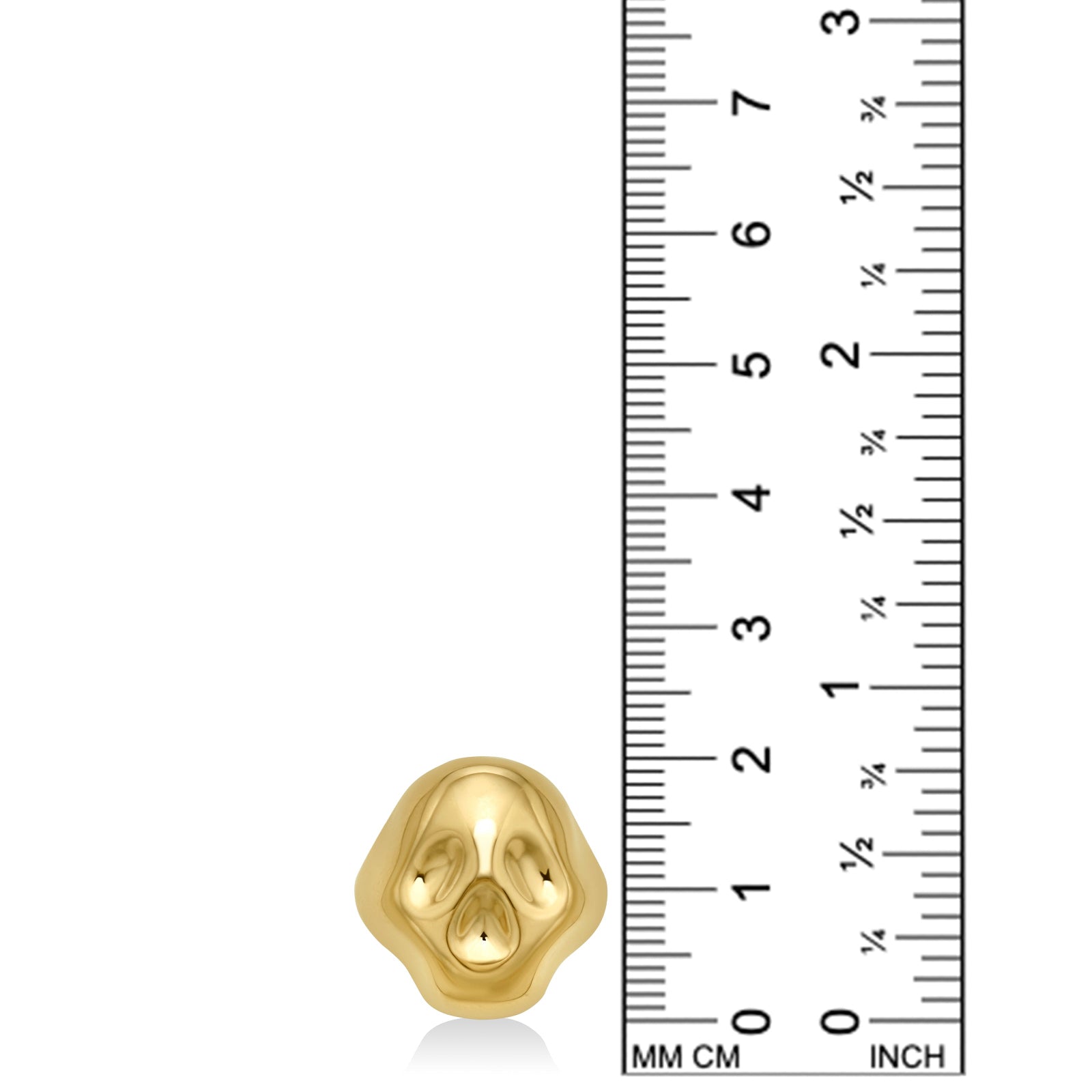 A rounded stylized skull ring sits next to a ruler showing it to be 20mm tall. It is made of 14k recycled yellow gold.