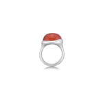 A molten pebble ring cast in recycled sterling silver with a carnelian stone from AMANDA PEARL sits on a white background with drop shadow.