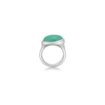 A molten pebble ring cast in recycled sterling silver with a chrysoprase stone from AMANDA PEARL sits on a white background with drop shadow.