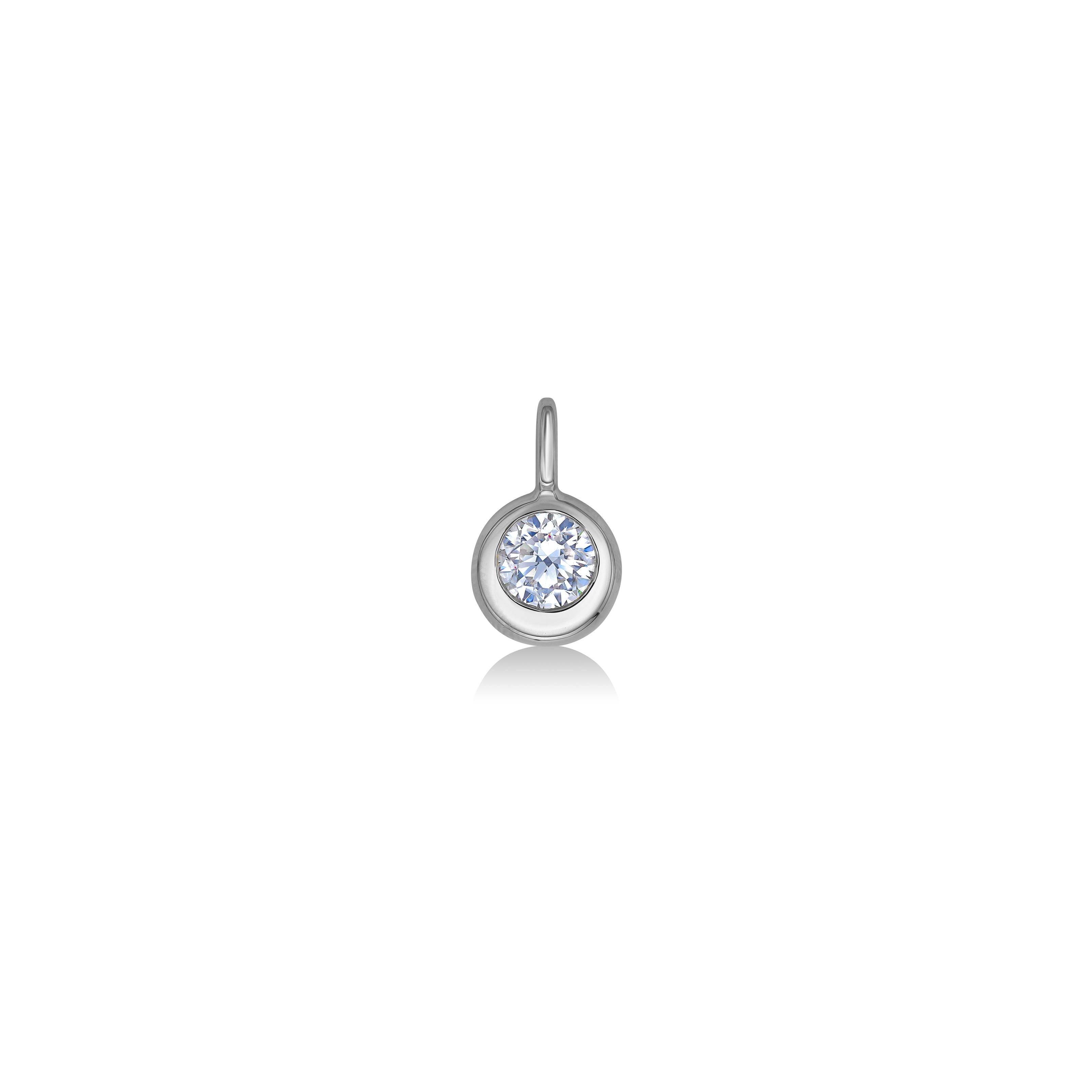 Molten solitaire round charm in 14K white gold featuring a diamond shot from a head on view on a white background. 