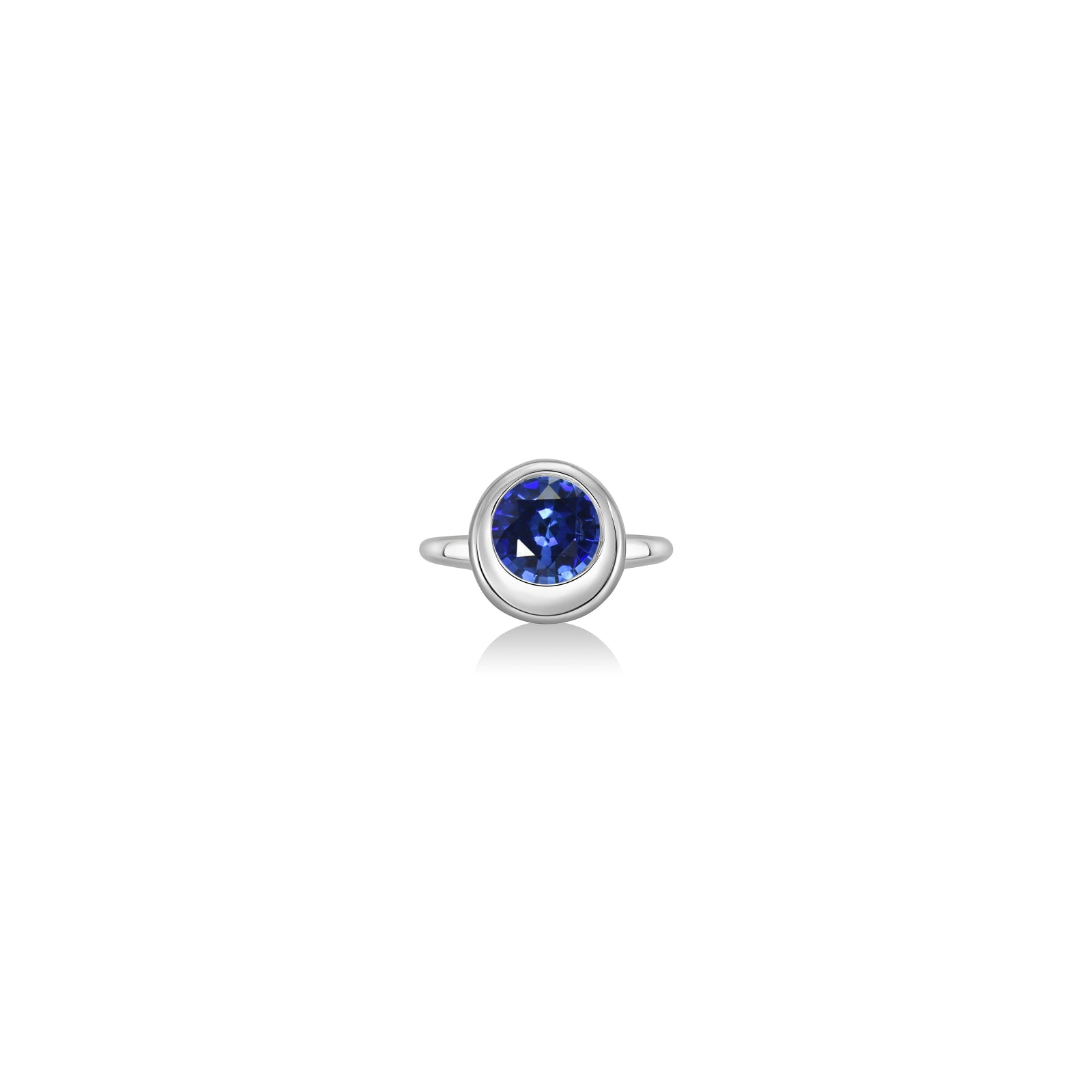 Molten solitaire ring in recycled 14k white gold with a round, cultivated ruby on a white background. 