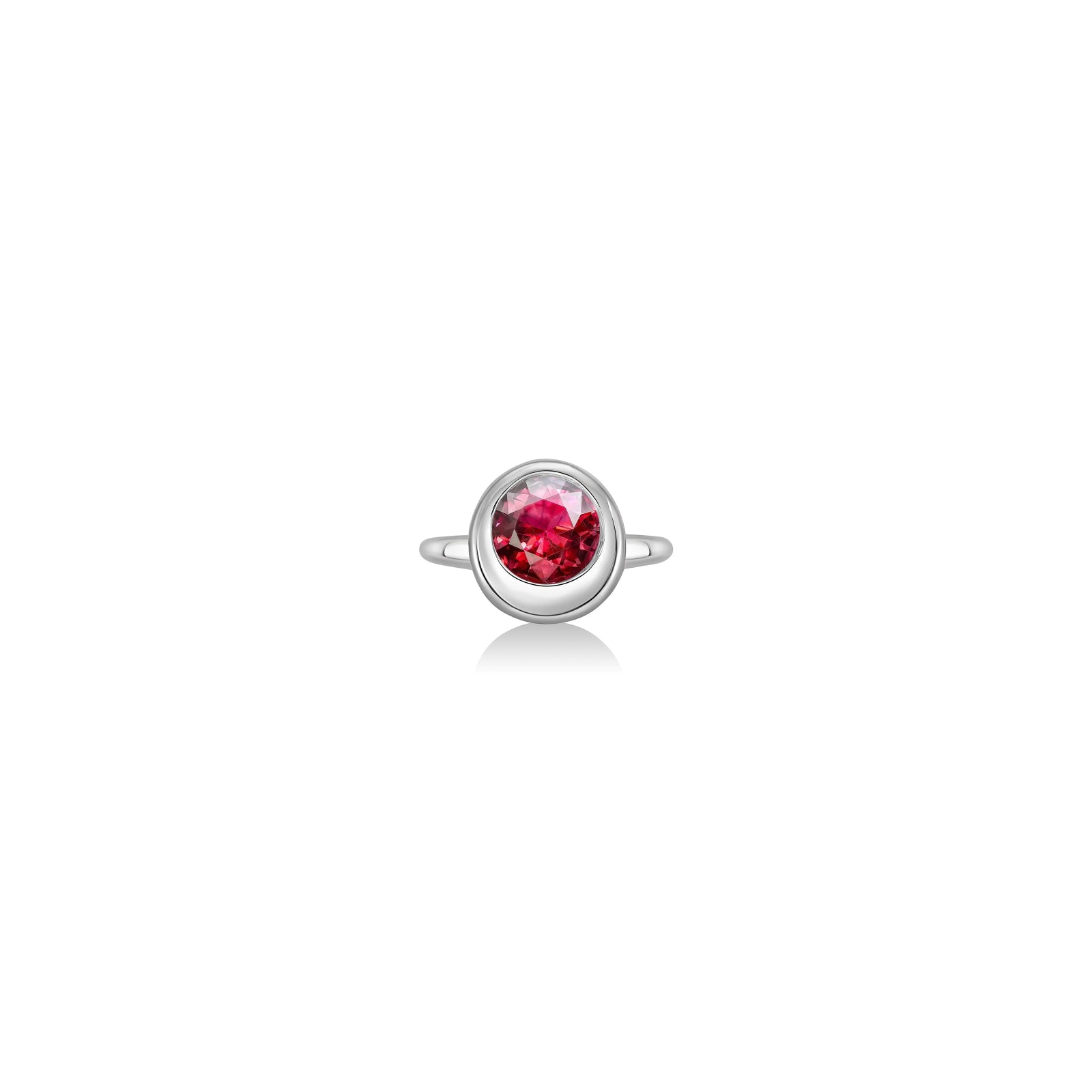 Molten solitaire ring in recycled 14k white gold with a round, cultivate ruby on a white background. 