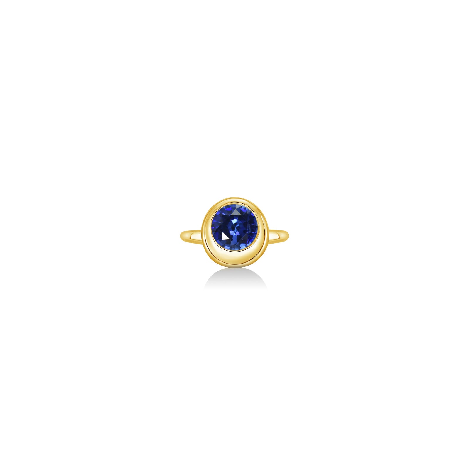 Molten solitaire ring in recycled 14k yellow gold with a round, cultivate sapphire on a white background. 