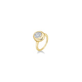 tilt view of round molten solitaire ring in yellow gold against a white background