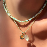 Peruvian Green Faceted Opal Necklace layered over peridot slim gemstone necklace with prehnite drop charm, and round molten solitaire charm with citrine on the neck.