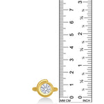 Quill Bezel Ring top view in yellow gold - against a ruler on a white background.