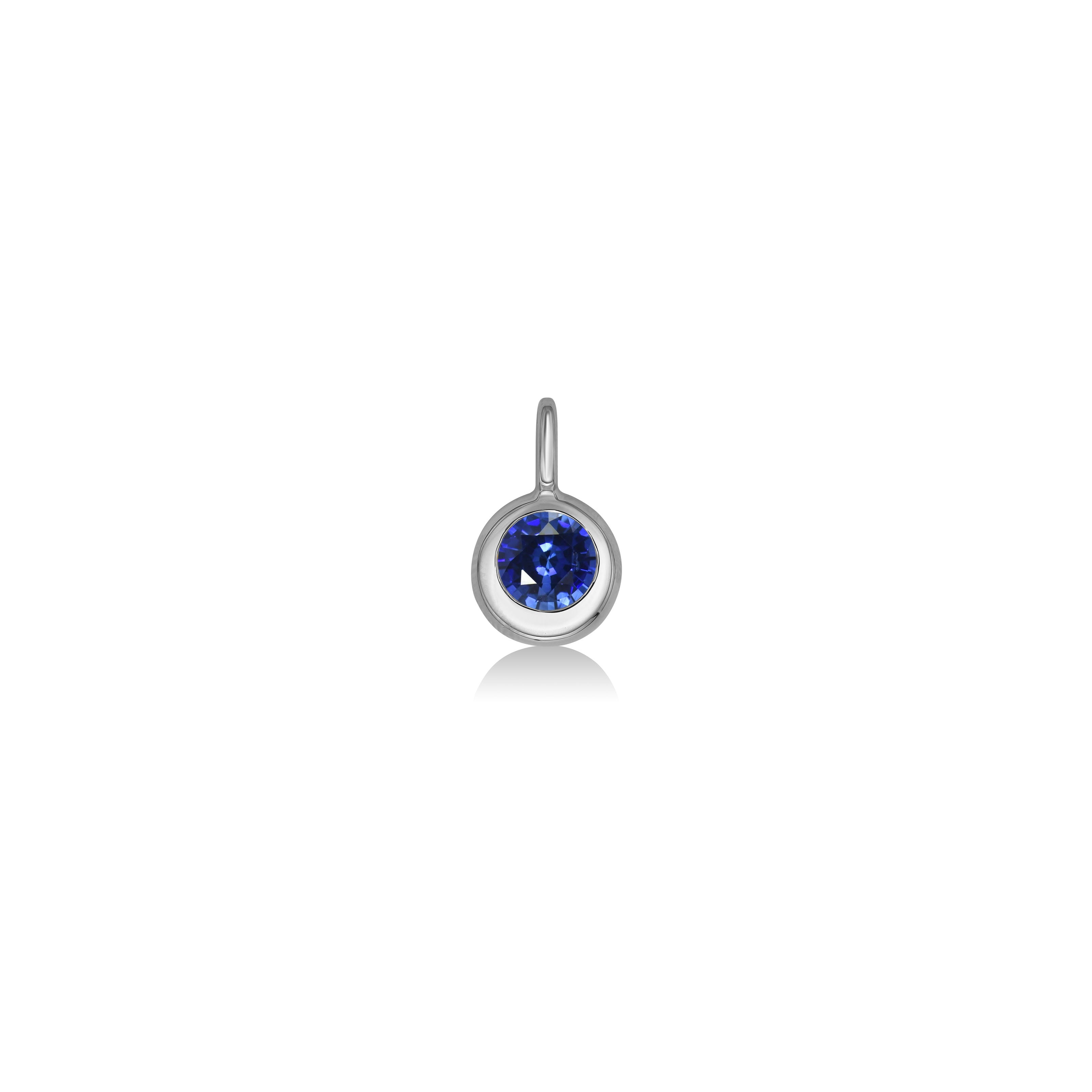 AMANDA PEARL Molten solitaire pendant in recycled 14k white gold with a round, cultivated sapphire on a white background. 