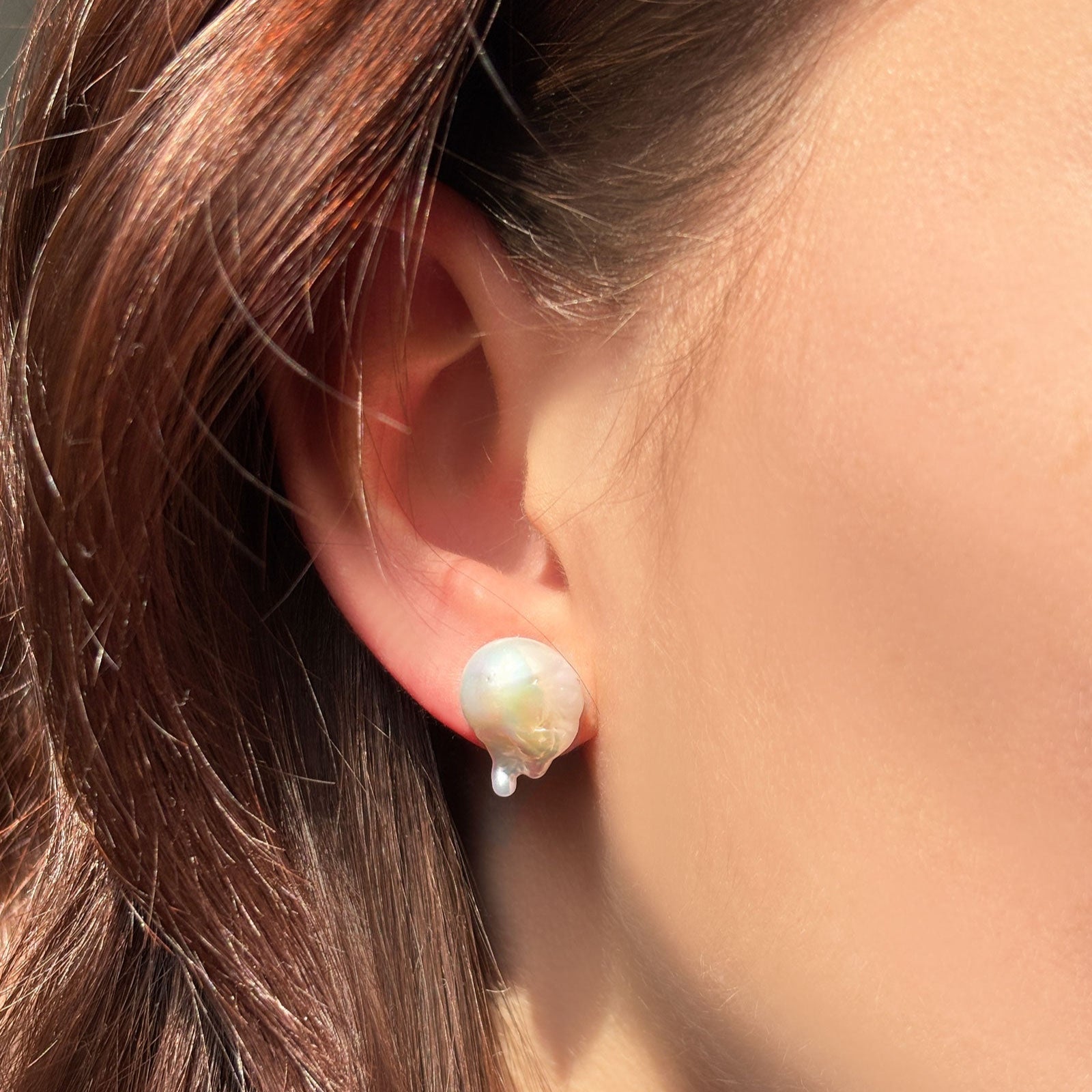 Baroque Pearl Stud Earring with 14K gold post, styled on an ear