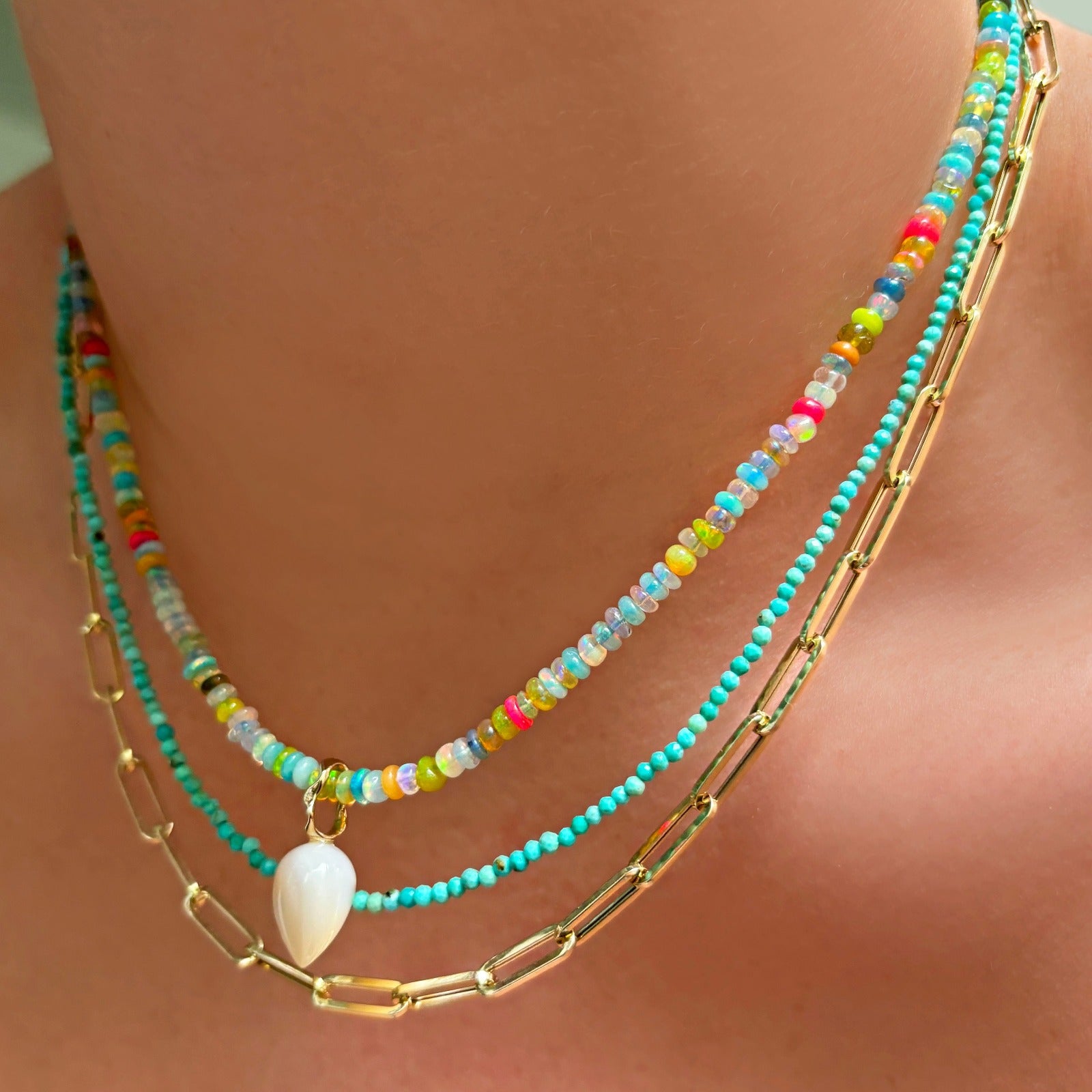 14k gold semi-hallow Chunky Paperclip Chain Necklace styled with Mermaid Opal Necklace, Turquoise Slim Gemstone necklace and a Mother of Pearl Acorn Drop Charm. 