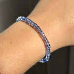 AMANDA PEARL denim blue faceted sapphire bracelet on a model's wrist.