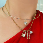 14K Gold Wire Choker Necklace styled with a diamond charm attached layered with a gold bead chain with charms attached