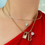 14K Gold Wire Choker Necklace styled with a diamond charm attached layered with a gold bead chain with charms attached