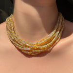 Eclipse opal necklaces layered on the neck.