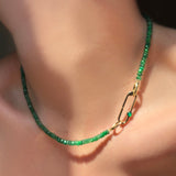 Faceted Emerald Necklace with evolution clasp, attached with a Paperclip Charm lock with green onyx cabochon on a model's neck.