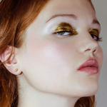 Small Molten stud on a model with golden eye shadow