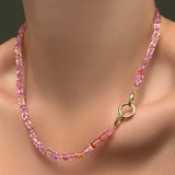 AMANDA PEARL Hibiscus Sapphire Necklace with a 13mm plain round charm lock on a model's neck.