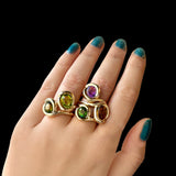 14k recycled gold Molten Knot Rings stacked together styled on a hand
