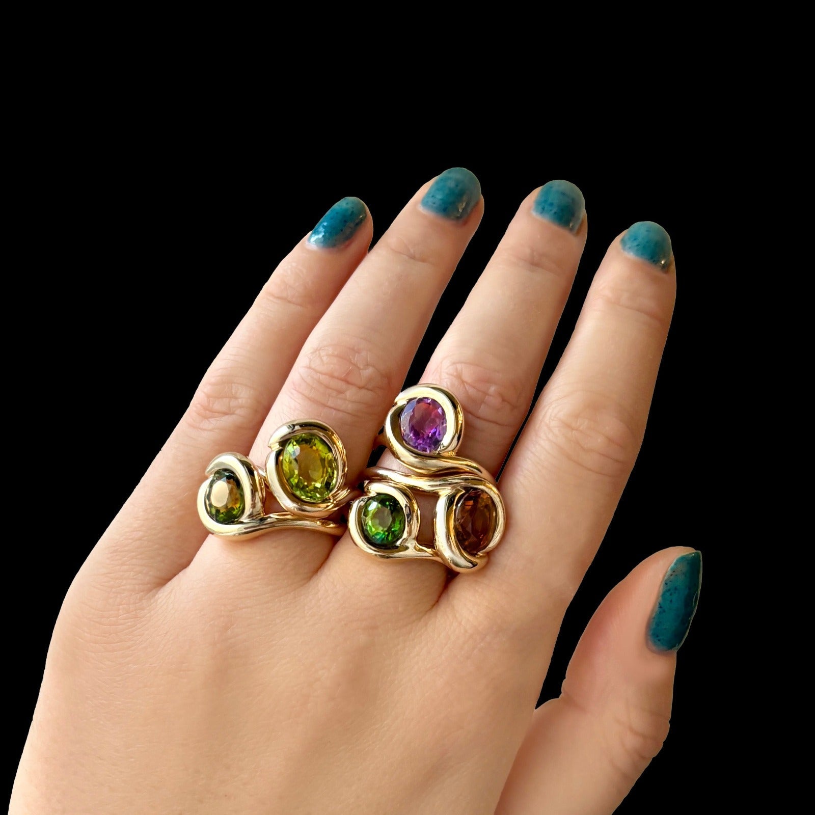 14k recycled gold Molten Knot Rings stacked together styled on a hand