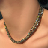 labradorite heishi necklace on neon and black thread layered on a model's neck.
